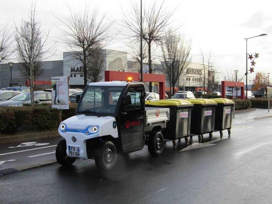 Collecte des bacs de déchets triés par un agent Veolia